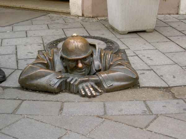Sehenswürdigkeit in Bratislava (Hauptstadt der Slowakei, deutsch: Pressburg) zeigt eine Statue, die aus einem Kanaldeckel herausschaut, das sog. (auf Deutsch: Gucker)