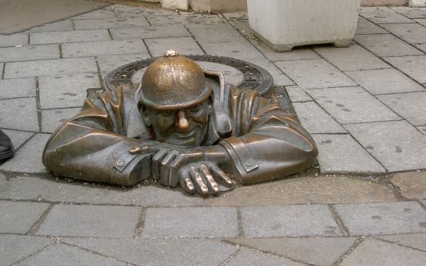 Sehenswürdigkeit in Bratislava (Hauptstadt der Slowakei, deutsch: Pressburg) zeigt eine Statue, die aus einem Kanaldeckel herausschaut, das sog. (auf Deutsch: Gucker)